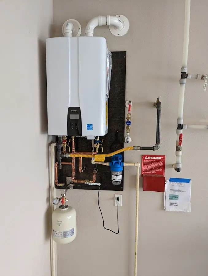 Professional plumber installing copper piping in a Cherry Hills Village home